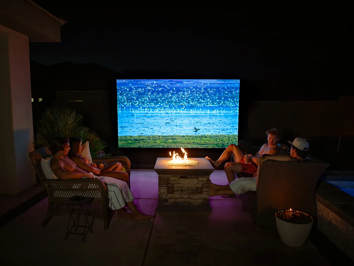 Friends watching television in a home cinema